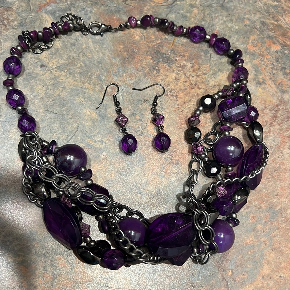 Women’s purple necklace with earrings.